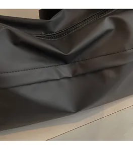 Detail of waterproof matte black fabric and durable zipper on the crossbody bag