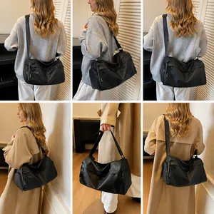 Detailed views of a black large capacity nylon shoulder bag with adjustable wide strap