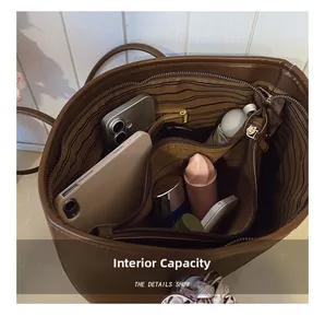 Detailed interior view of a dark brown tote bag showing large capacity and multi-pocket layout