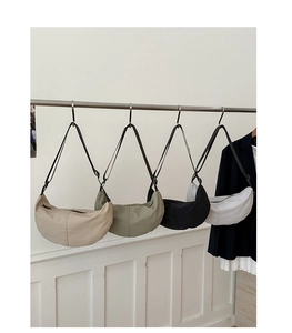 Nylon crescent crossbody bags in beige, green, black and gray on hooks