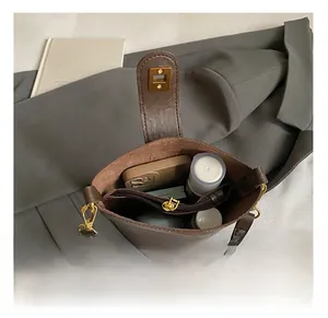 Top view of dark brown leather bucket bag showing interior capacity and zipper pocket