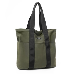 Detail of olive green tote bag with wide black canvas handles and front pockets