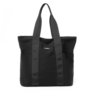 Detailed view of NOCOBAG black tote bag made of durable nylon with branded logo tag