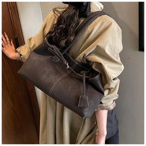 Détail d'un grand sac cabas marron en similicuir avec surpiqûres blanches contrastées