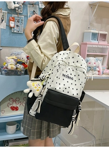 Detail of star print backpack with plush charm and RKDBAG label in canvas fabric