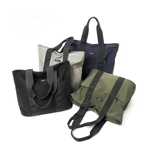 Detail view of large capacity nylon tote bags in black, grey, navy, and army green
