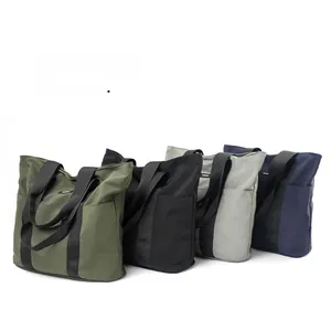 Detail view of large capacity nylon tote bags with wide shoulder straps in four colors