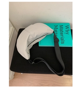 Detailed close-up of white crescent crossbody bag with durable stitching and nylon strap
