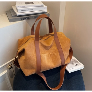 Detailed view of ginger yellow suede tote bag with brown straps and zipper closure
