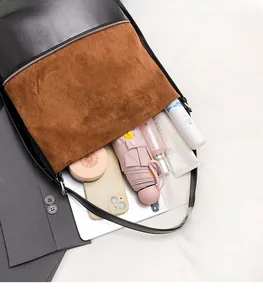 Detail shot of large capacity bucket bag showing interior space for phone and umbrella