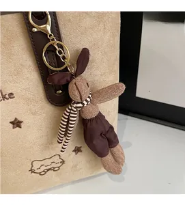 Detail of embroidered star and cat motifs on beige tote bag with a cute rabbit pendant