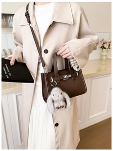 Dark brown pebble leather tote bag with silver turn-lock and fluffy rabbit charm detail