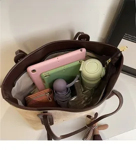 Interior view of large tote bag showing capacity for tablets, umbrella, and wallet