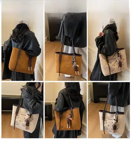 Detail view of large capacity tote bag featuring cute cat embroidery and soft suede texture