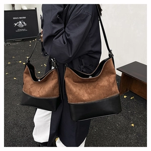 Size comparison of large and small brown suede bucket bags with black leather trim