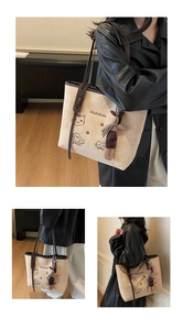 Detailed views of large beige tote bag with cat embroidery and plush rabbit pendant
