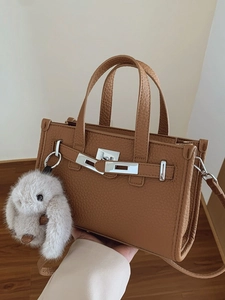 Brown lychee pattern tote bag with metal lock and a cute white plush bunny charm