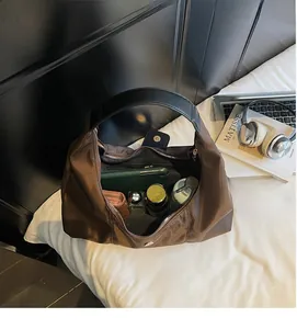 Interior view of brown hobo bag showing capacity for phone, wallet, and essentials