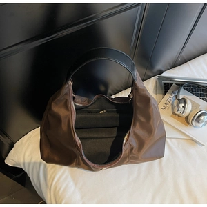 Detail view of large nylon crescent bag showing the spacious interior and zipper pocket