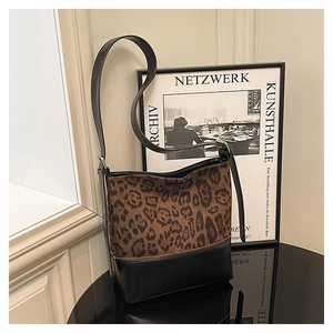 Detail of leopard print stitching on black leather bucket bag with metallic zipper