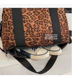 Close-up of leopard print travel bag featuring a separate zipper compartment for shoes