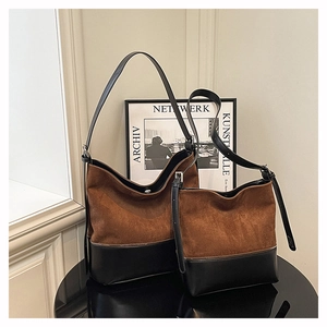 Set of two brown suede bucket bags in different sizes with black leather trim detail