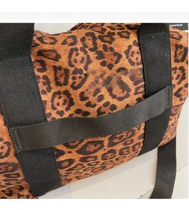 Leopard print travel bag detail showing the convenient luggage sleeve for suitcases