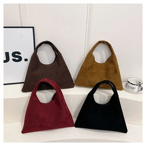 Detail view of four large matte suede hobo bags in brown, yellow, burgundy and black