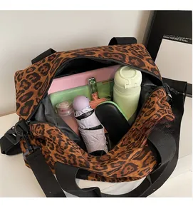 Detail view of large leopard print travel bag showing spacious interior with essentials