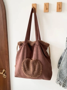 Brown canvas tote bag featuring a plush fleece heart pattern and warm winter texture
