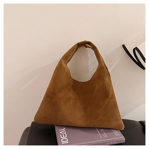 Macro view of brown suede matte leather tote bag texture and wide handle design