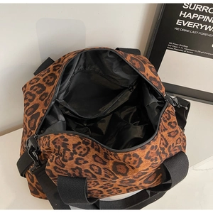 Top view of large leopard print travel bag showing interior lining and zipped pocket