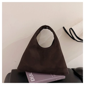Close-up of minimalist dark coffee frosted leather tote bag with unique triangle design