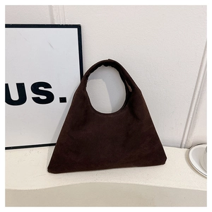 Detail of vintage coffee brown suede tote bag with triangular structure and matte finish