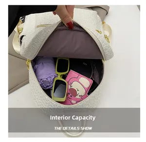 Interior view showing the large capacity of the tweed backpack with daily essentials
