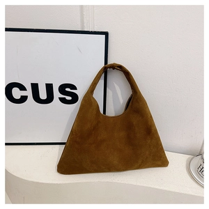 Close-up of the vintage brown suede leather texture on a triangular tote bag