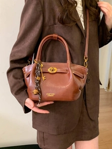 Elegant brown vintage leather bucket bag with gold oval twist lock and round top handle
