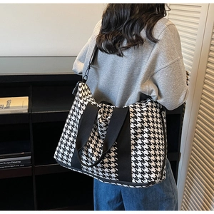 Large capacity travel tote bag with black and white houndstooth pattern and shoulder strap