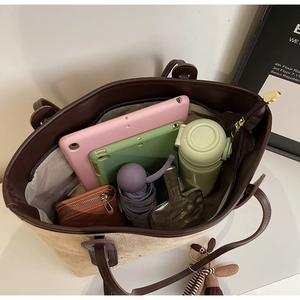 Large tote bag interior showing ample storage space for laptop, bottle, and umbrella