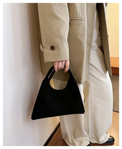 Minimalist black matte tote bag styled with a khaki coat for an elegant casual look
