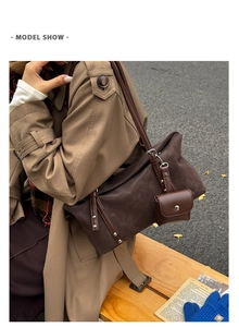 Detail view of vintage dark brown suede shoulder bag with mini pouch and silver rivets
