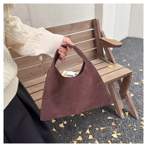 Detail of a dark brown frosted suede tote bag with minimalist triangular design