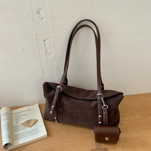 Detail of dark brown suede tote bag with matching mini pouch and leather shoulder strap