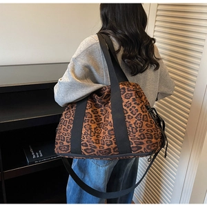 Close-up of leopard print travel bag with durable straps and expandable zipper base