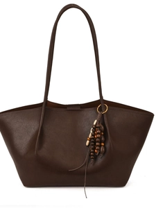 Minimalist large brown leather tote bag with elegant beaded tassel and long shoulder straps