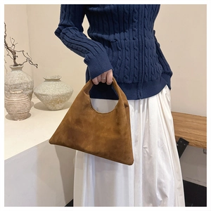 Detail of vintage matte brown tote bag showing the suede texture and minimalist handle