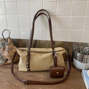 Detail of minimalist tote bag with detachable brown pouch and adjustable strap
