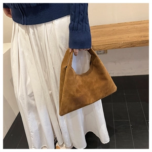 Close-up of brown frosted faux suede tote bag featuring fine velvet texture and strap