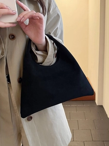 Minimalist black matte suede tote bag styled with a khaki trench coat for office