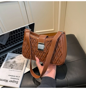 Detailed view of brown woven texture PU leather handbag with square silver metal clasp